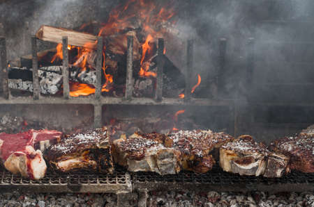 Thick slices of meat from chianina cow grilling over the embersの写真素材