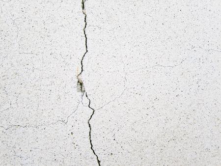 extended crack on a white wallの写真素材