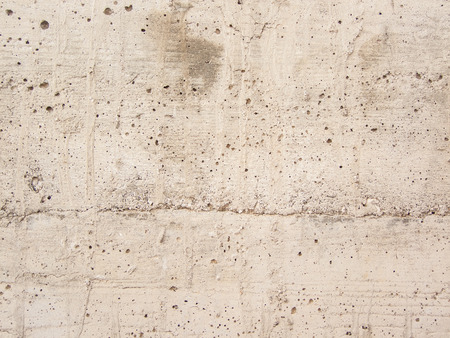 white gravel concrete wall with perforationsの写真素材