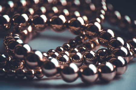 Golden beads low key luxury dark backgroundの写真素材