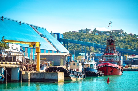 Boats near seacoast and southern town on the hill on background. Touristic scenic landscapeの写真素材