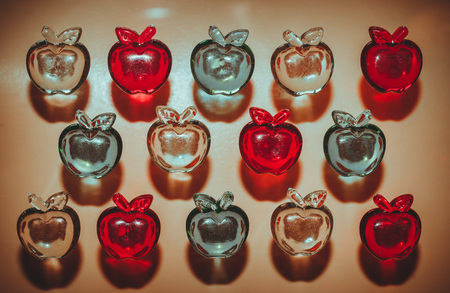 3 rows of colorful plastic transparent apples on light background top viewの写真素材
