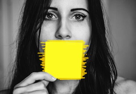 Woman with a sticker near her mouth as a concept of female rights and necessity of talking and writing about that from each person. Copy space for any textの写真素材