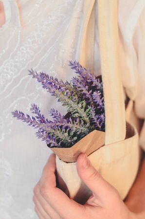 Close-up textile bag and a bunch of lavender in paper as a concept of biodegradable package and plastic freeの写真素材