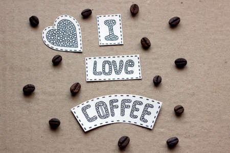 I love coffee lettering  with grains of coffee on a cardboard background. Can be used for print of clothes, card, invitation, posters, placards, banners.の写真素材