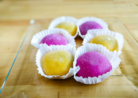 Colourful Japanese Mochi in a transparent plate on wooden background.の写真素材