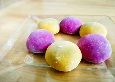 Colourful Japanese Mochi in a transparent plate on wooden background.の写真素材