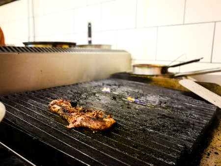 Delicious juicy meat steak cooking on grill. Silicone cooking brush. Aged prime rare roast grilling fresh marble tenderness beef. Prime beef fry on electric roaster, rosemary black pepper oil.のeditorial素材