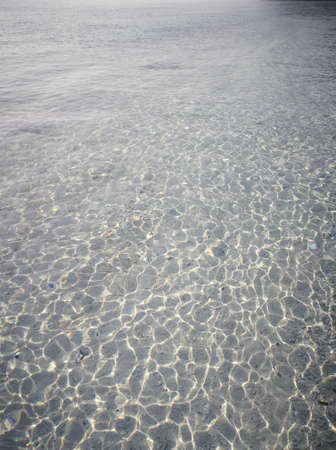 Photo of the amazing crystal clear water, in the shallow shimmering part of the pristine beach of Redang Island. Popular for snorkelling tourism.の写真素材