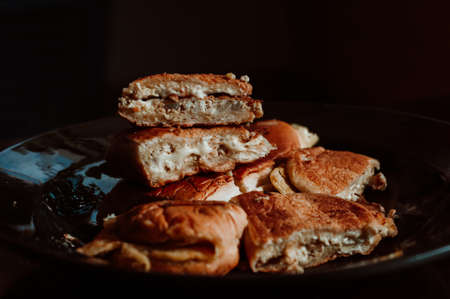 Close up of Malaysian well known food "Roti John" on a dark background. John bread or "Roti John" made of eggs, minced meat and bread, served with melted cheese. Popular during Ramadan.の写真素材