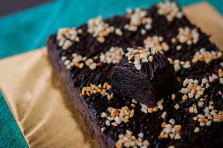 Chocolate Cake Brownie Squares Drizzled With Chocolate and Walnuts. Closeup view, selective focusの写真素材