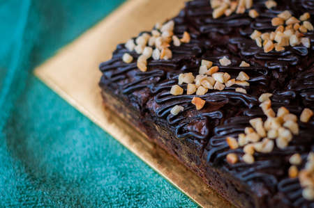 Chocolate Cake Brownie Squares Drizzled With Chocolate and Walnuts. Closeup view, selective focusの写真素材