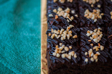 Chocolate Cake Brownie Squares Drizzled With Chocolate and Walnuts. Closeup view, selective focusの写真素材