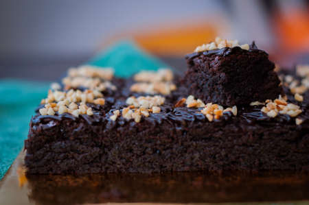 Chocolate Cake Brownie Squares Drizzled With Chocolate and Walnuts. Closeup view, selective focusの写真素材