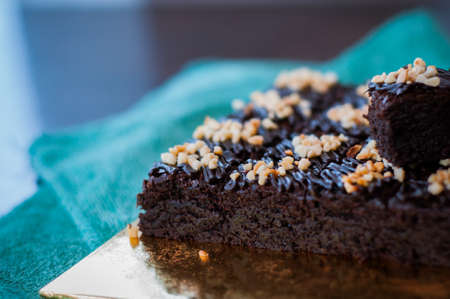 Chocolate Cake Brownie Squares Drizzled With Chocolate and Walnuts. Closeup view, selective focusの写真素材