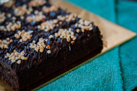 Chocolate Cake Brownie Squares Drizzled With Chocolate and Walnuts. Closeup view, selective focusの写真素材