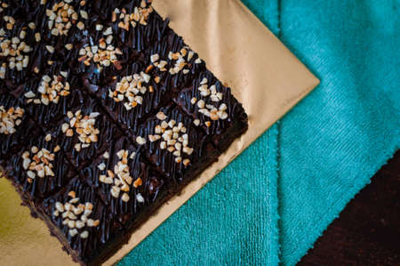 Chocolate Cake Brownie Squares Drizzled With Chocolate and Walnuts. Closeup view, selective focusの写真素材