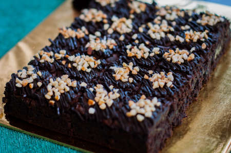 Chocolate Cake Brownie Squares Drizzled With Chocolate and Walnuts. Closeup view, selective focusの写真素材
