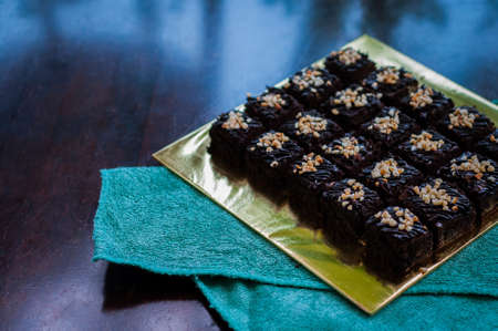 Chocolate Cake Brownie Squares Drizzled With Chocolate and Walnuts. Closeup view, selective focus
