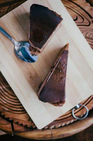 Burnt chocolate cheesecake on brown wooden background. selective focus
