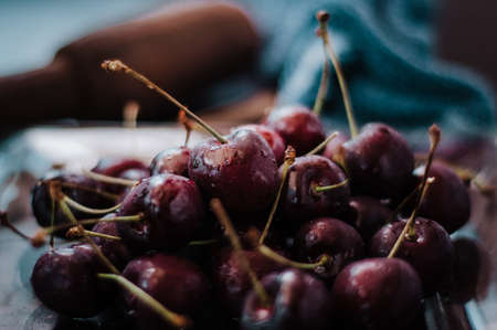 Fresh cherry on clear plate on wooden background. fresh ripe cherries. sweet cherries.の写真素材