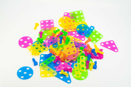 Colorful plastics puzzle in various shapes isolated on white background.の写真素材