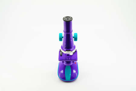 Purple microscope isolated on white.