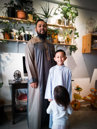 Portrait of asian father and son on hari raya morning.