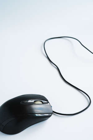 Modern black computer mouse on white backgroundの写真素材