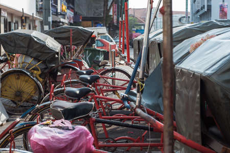 Georgetown Penang - April 25 2019 :  Vintage Trishaw stop beside road for service travellerのeditorial素材