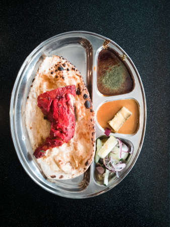Indian Cuisine Tandoori Roti And Chicken Served in Metal Plate Also Called Chapati, Flatbread, Naan...