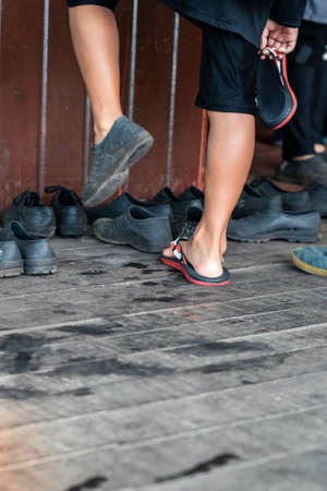 An unidentified boy is trying out black shoes that fits his feet.の写真素材