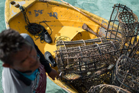 Rusty fish traps on the boat with the crystal clear water in the background in Semporna, Sabah.のeditorial素材