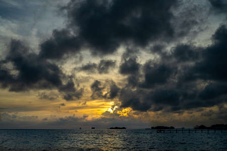 Sunset background and sun beam on the open sea with beautiful clouds.の写真素材