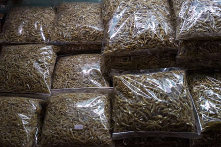 Dried anchovies packed in a plastic container on display in a market in Sabah, Malaysia.の写真素材