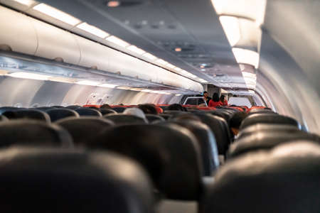 KLIA, Malaysia - November 24, 2019: Inside airplane view with stewart and stewardess busy inside...