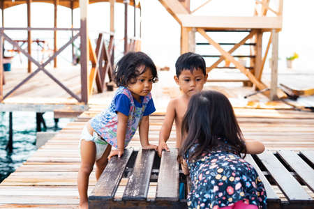 Semporna, Malaysia - NOvember 27, 2019: Children playing together at the water chalet resort in Egang - Egang near Pulau Bum Bum, Sabah.のeditorial素材