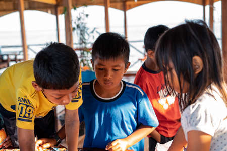 Semporna, Malaysia - NOvember 27, 2019: Children playing together at the water chalet resort in Egang - Egang near Pulau Bum Bum, Sabah.のeditorial素材