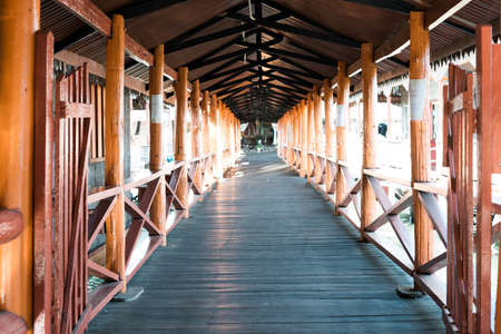 Semporna, Malaysia - Nov 27, 2019: Perspective of the wooden bridge. photograph of the bridge. Perspective. Gallery.の写真素材