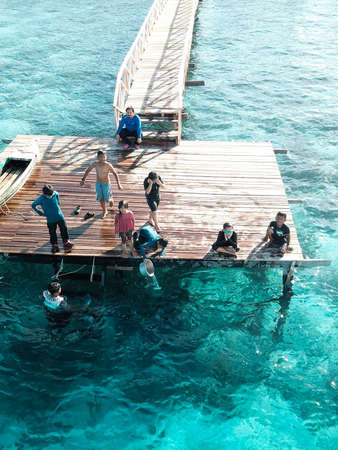 Aerial view of children playing at pier, in Semporna, Borneo Sabah, Malaysia.の写真素材