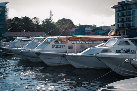 Semporna, Malaysia - November 28, 2019 :  Boats near the Harbour City in a sunny day.