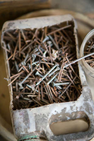 Rusty nails in a recycled oil plastic box. Top view.の写真素材