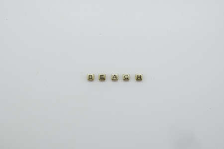 BEACH word made with gold coloured blocks.の写真素材