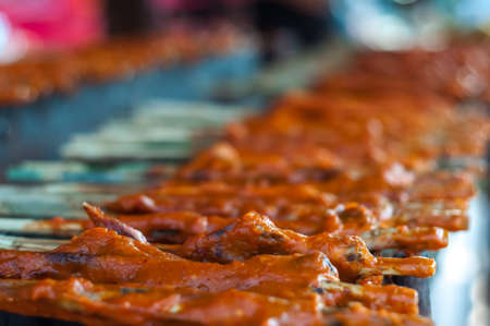 Traditional Thai chicken barbecue with curcuma powder herb for halal food in south of Thailand.の写真素材