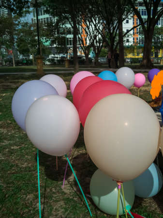 colorful balloons over green natural background - celebration, children and birthday party conceptの写真素材