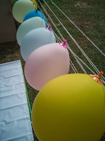 colorful balloons over green natural background - celebration, children and birthday party concept