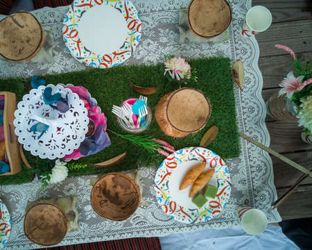 Eco friendly picnicat the park. Tablecloth, recycled plates, healthy food and accessories, top viewの写真素材