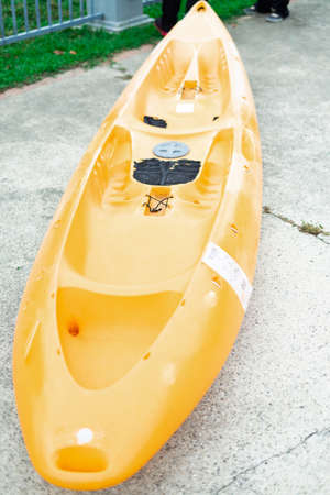 Yellow canoe or kayak boat on the concrete floor.の写真素材