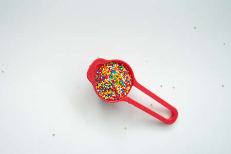 Colourful Sugar sprinkles, decoration for cake, ice-cream and cookies. Top view, Flat lay on white background. Copy space.の写真素材