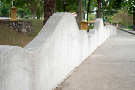 Side perspective on a modern design concrete fence style in the park.の写真素材